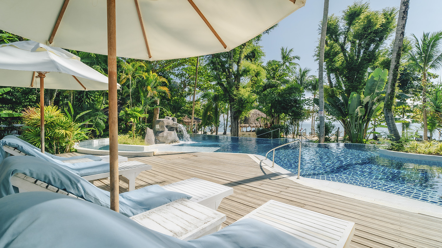 Sun loungers and parasols on the timber pool deck