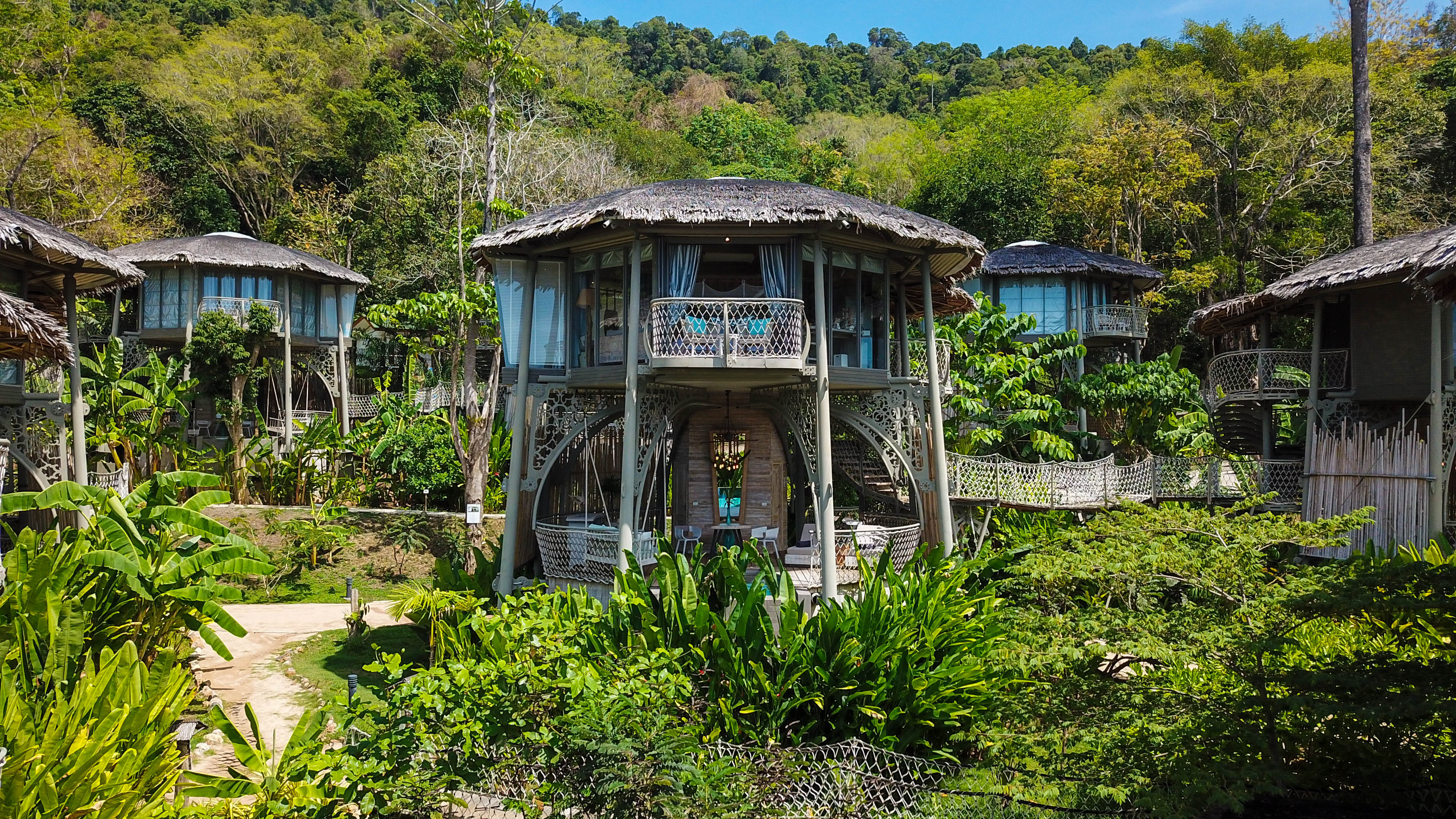 Thatched treehouse villas raised on stilts among the jungle canopy